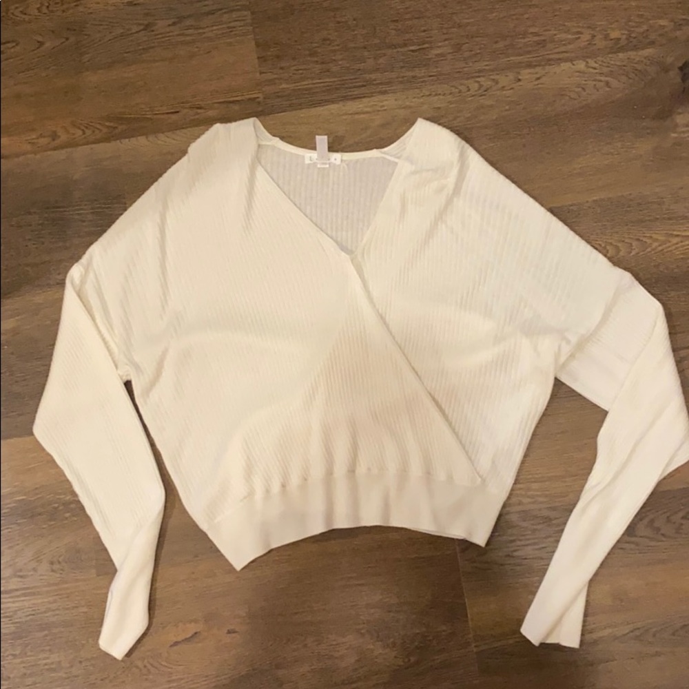 White LEITH sweater that has a wrap effect
